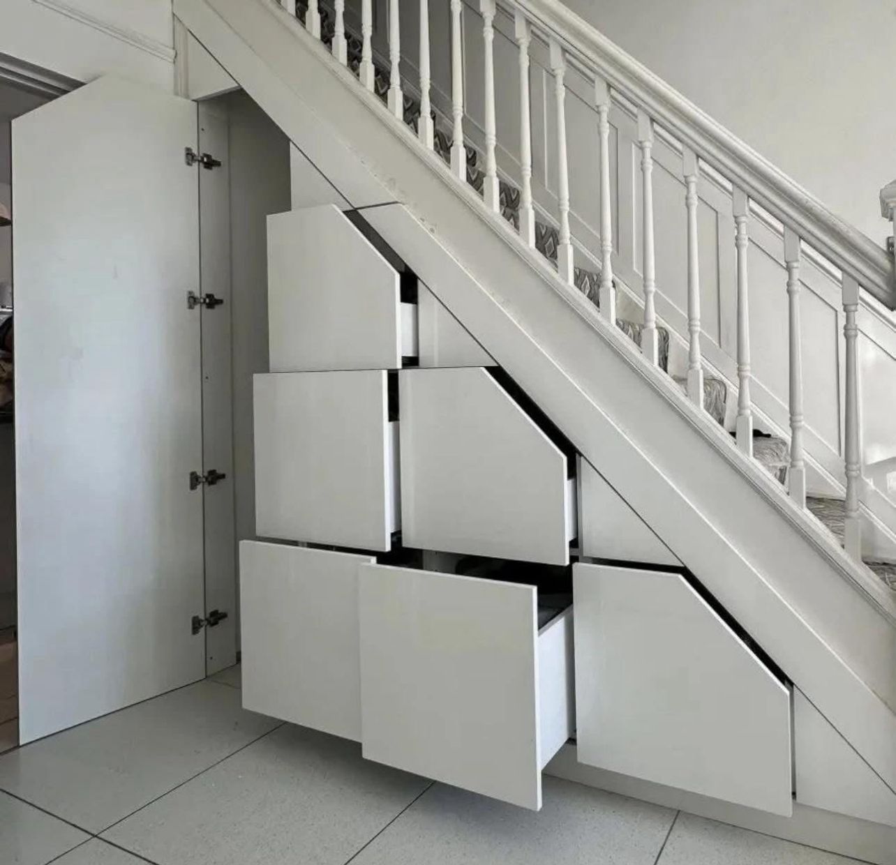 Custom under-stair storage unit with pull-out drawers and elegant wood finish