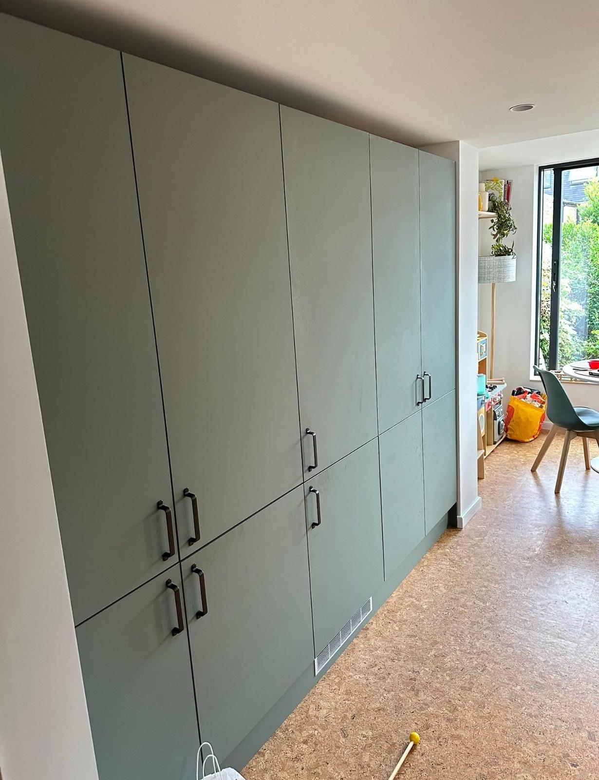 Large sage green storage unit with multiple compartments and modern design