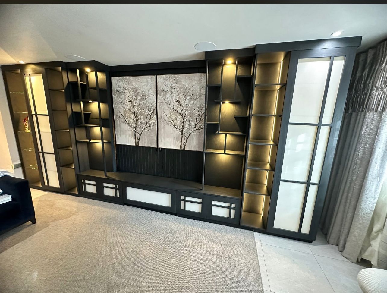 Multi-functional entertainment unit with sleek black and gold accent design